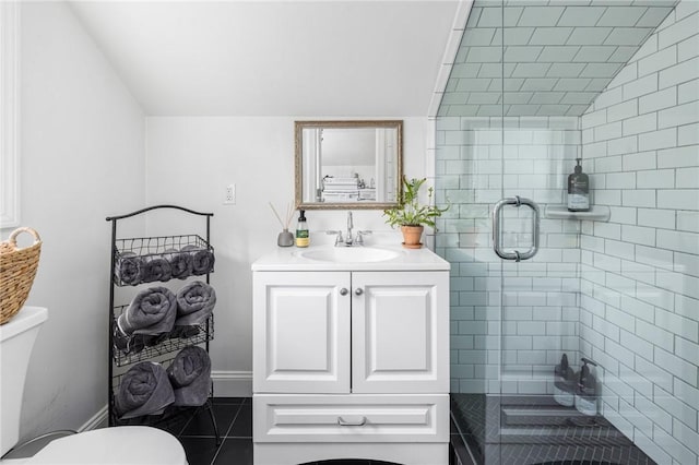 bathroom featuring vaulted ceiling, vanity, walk in shower, toilet, and tile patterned floors