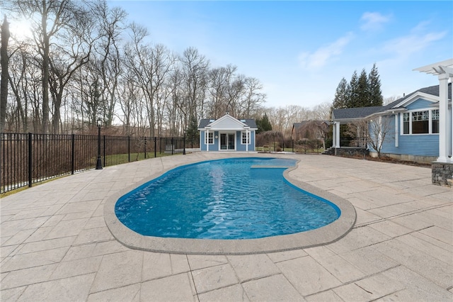 view of swimming pool with an outbuilding and a patio area