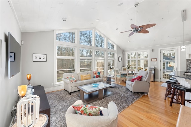 living room with ceiling fan, lofted ceiling, wood-type flooring, and a wealth of natural light