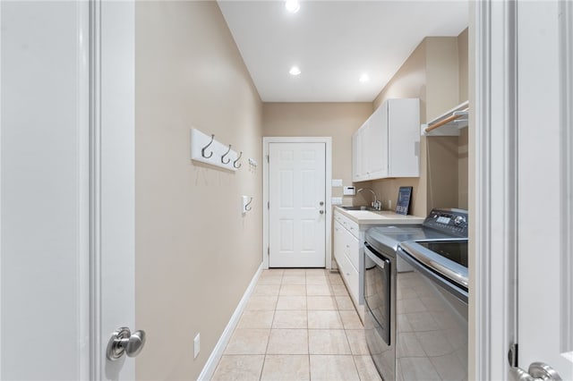 clothes washing area with cabinets, light tile patterned flooring, and separate washer and dryer