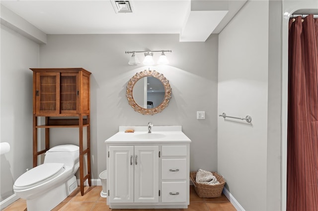 bathroom with vanity, tile patterned floors, and toilet