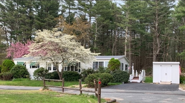 view of front of house featuring a storage shed