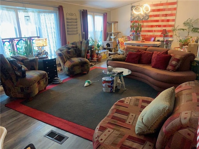 living room featuring ornamental molding and wood-type flooring