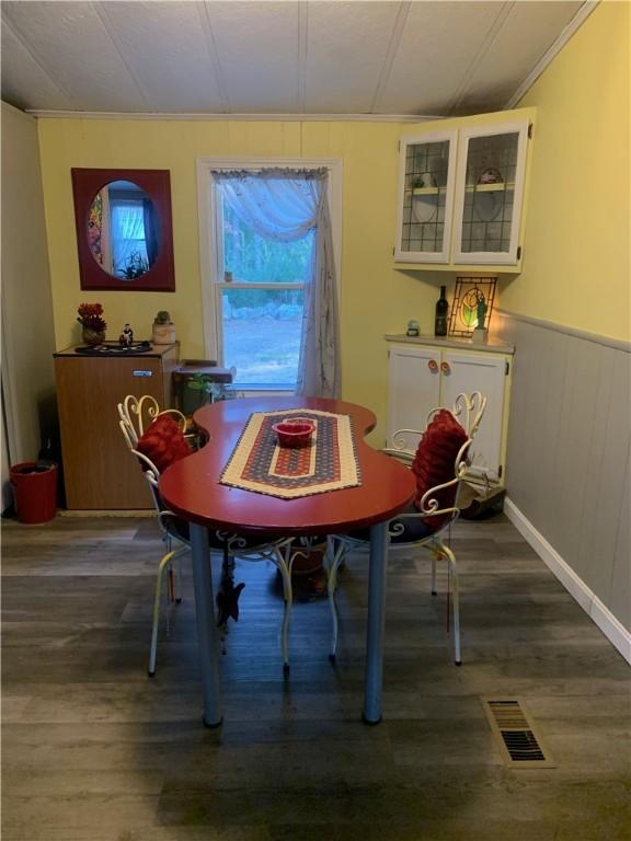 dining area featuring dark wood-type flooring