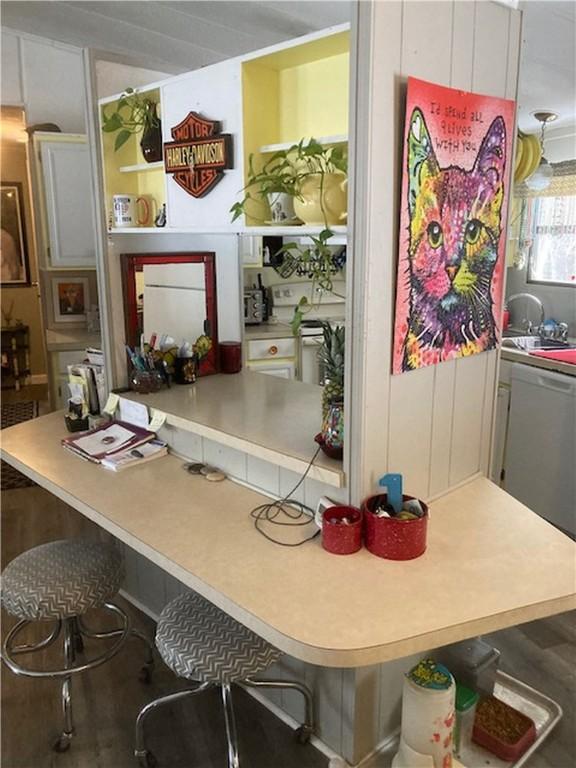 interior space with dishwasher, sink, and white cabinets