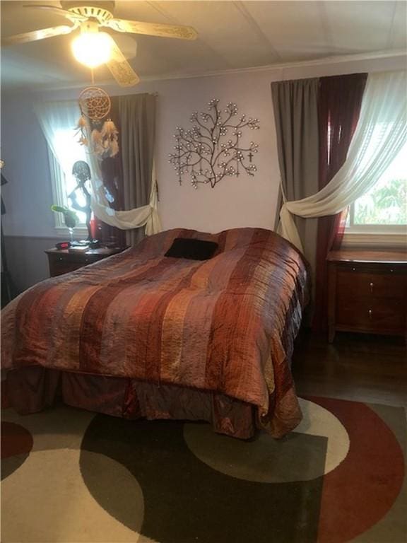 bedroom with ceiling fan and ornamental molding