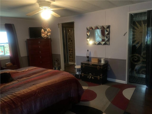 bedroom with crown molding, dark hardwood / wood-style floors, and ceiling fan