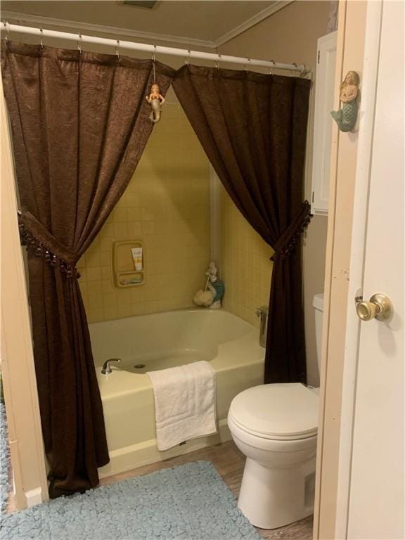 bathroom featuring shower / tub combo and toilet