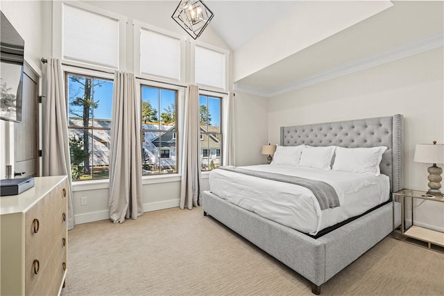 carpeted bedroom with high vaulted ceiling, a notable chandelier, and ornamental molding