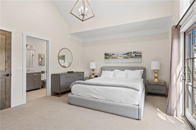 carpeted bedroom featuring crown molding, high vaulted ceiling, a notable chandelier, and ensuite bath