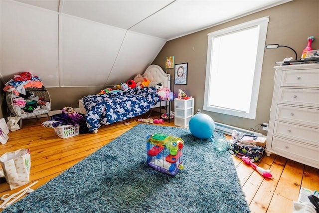 bedroom with lofted ceiling and hardwood / wood-style flooring