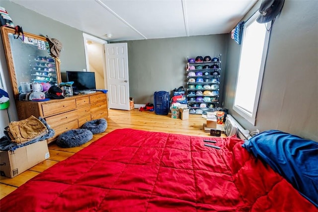 bedroom with hardwood / wood-style floors and multiple windows