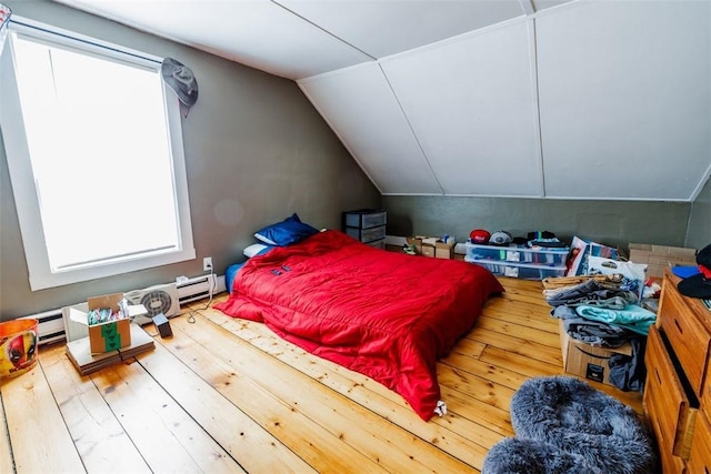 bedroom with hardwood / wood-style flooring and vaulted ceiling