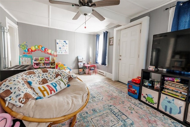 bedroom featuring wood-type flooring, ornamental molding, and ceiling fan