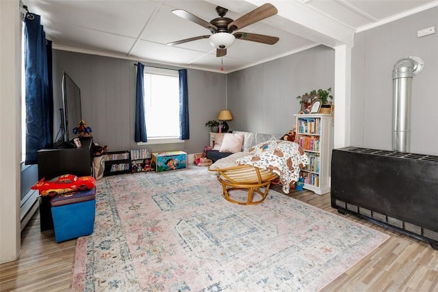 playroom featuring ornamental molding, hardwood / wood-style floors, and ceiling fan