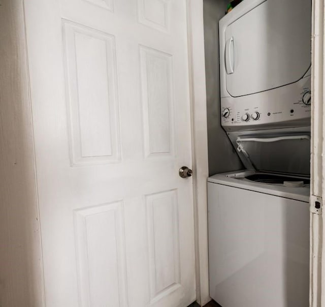 clothes washing area with stacked washer and dryer