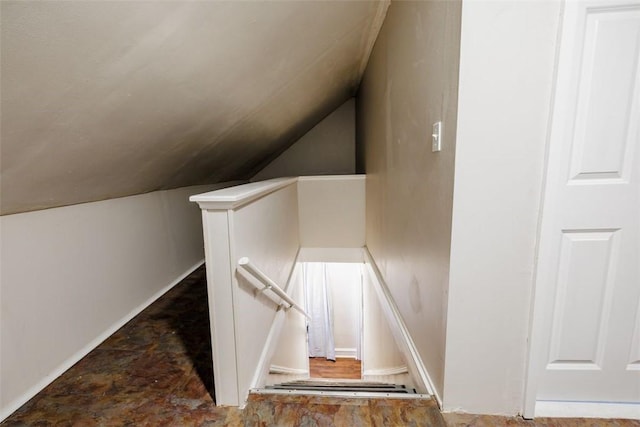 staircase featuring lofted ceiling