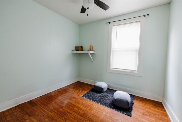 exercise room with hardwood / wood-style floors and ceiling fan