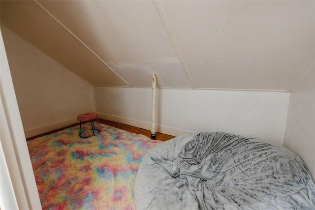 bedroom featuring hardwood / wood-style floors and vaulted ceiling