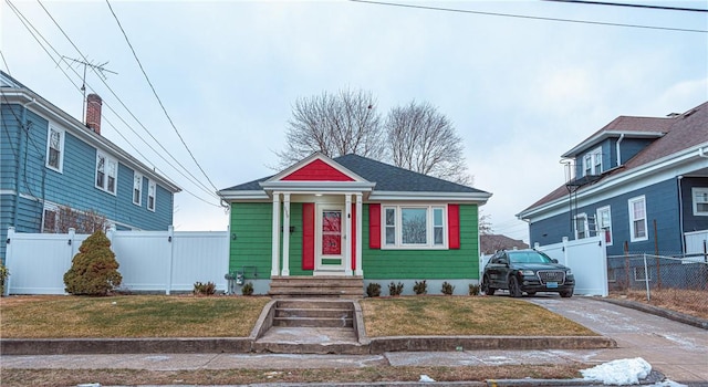 bungalow-style house with a front lawn