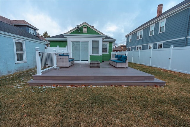 rear view of house with a wooden deck, a lawn, and outdoor lounge area