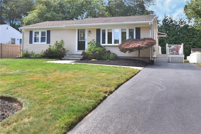 ranch-style home with a front lawn