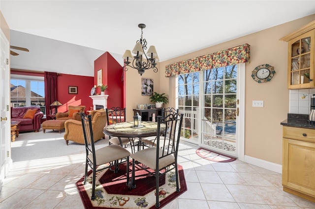 dining space featuring light tile patterned flooring and a chandelier