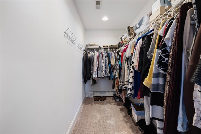 spacious closet with a baseboard radiator and carpet flooring