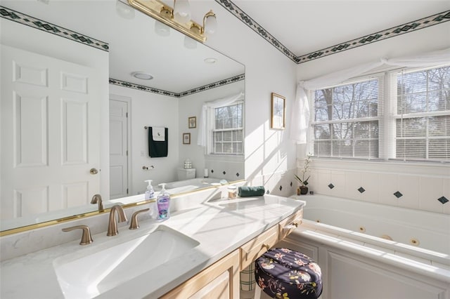 bathroom with vanity and a tub