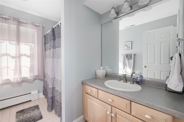 bathroom with a baseboard radiator, vanity, and tile patterned flooring