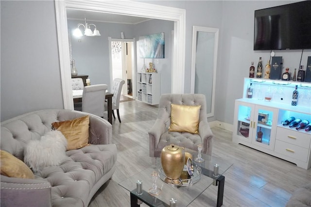 living room with an inviting chandelier and light hardwood / wood-style floors