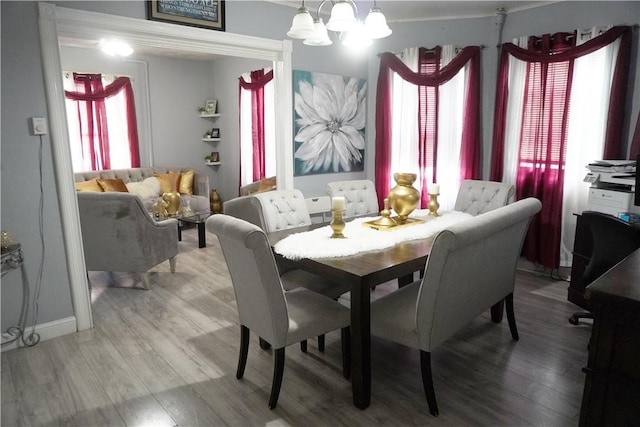 dining room featuring hardwood / wood-style floors and an inviting chandelier