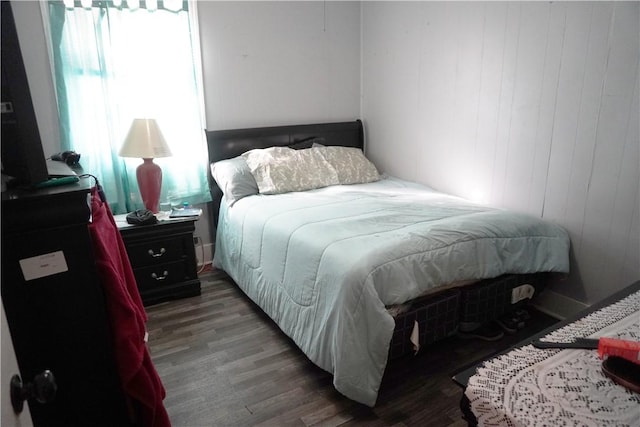 bedroom featuring dark hardwood / wood-style floors and multiple windows