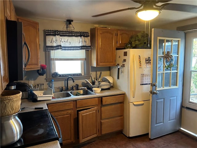 kitchen featuring sink, electric range, dark tile patterned floors, and white fridge