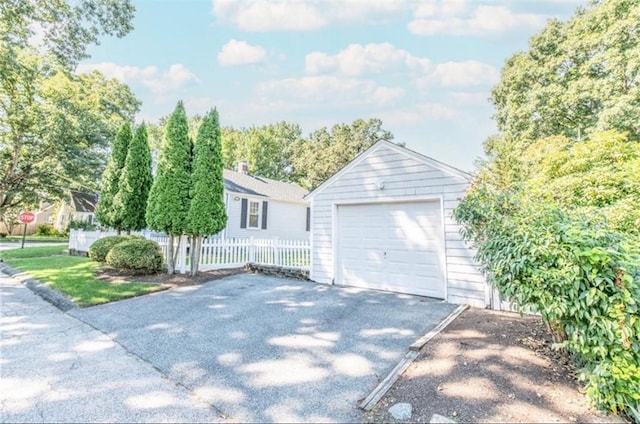 view of front of property with a garage and an outdoor structure