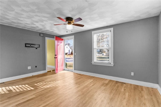 spare room with ceiling fan and light hardwood / wood-style floors