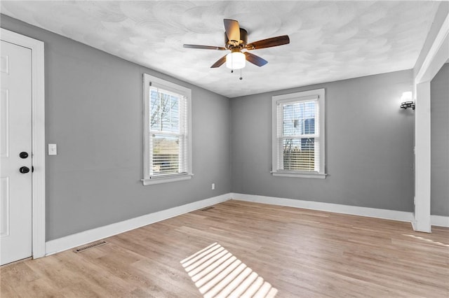 unfurnished room with ceiling fan and light hardwood / wood-style flooring