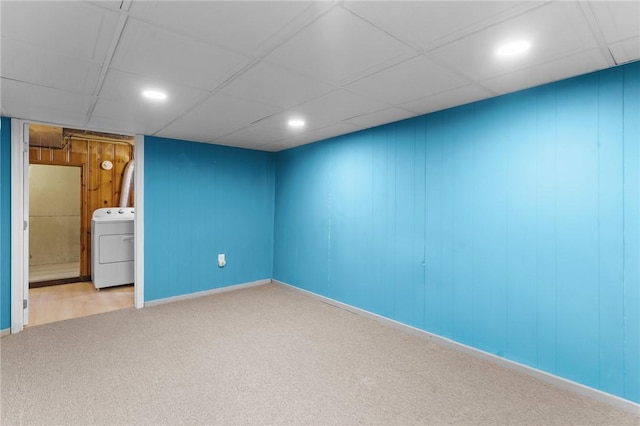 carpeted spare room featuring a drop ceiling and washer / clothes dryer