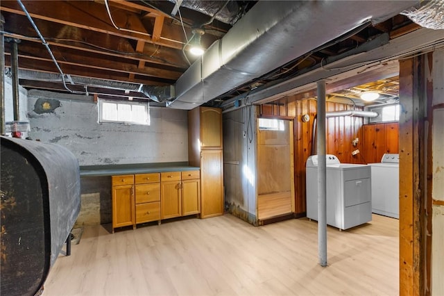 basement featuring separate washer and dryer and light hardwood / wood-style floors