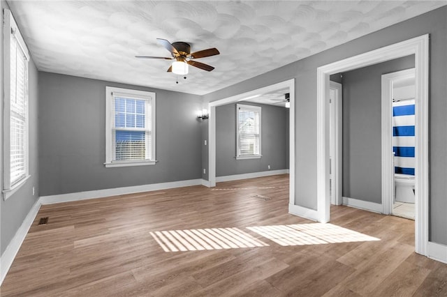 interior space with light hardwood / wood-style flooring and ceiling fan