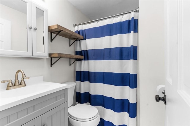 bathroom featuring vanity, toilet, and a shower with shower curtain