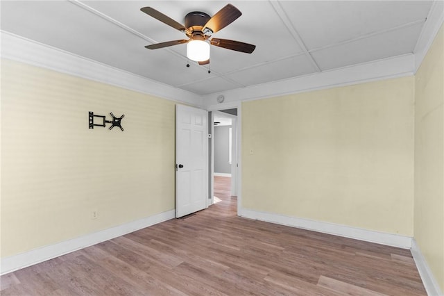 unfurnished room featuring ceiling fan, ornamental molding, and hardwood / wood-style floors