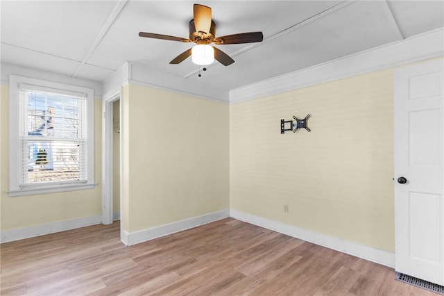 spare room featuring ceiling fan, ornamental molding, and light hardwood / wood-style floors