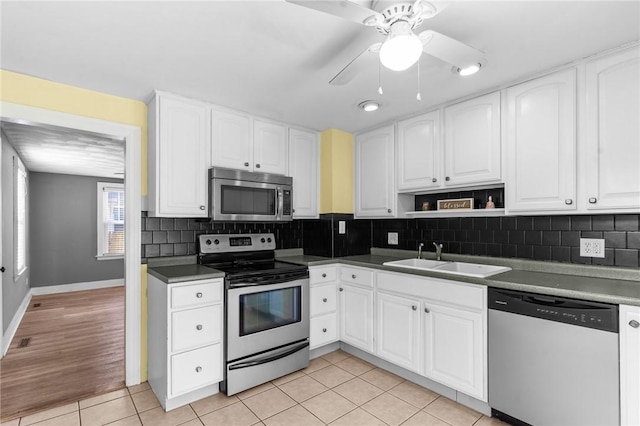 kitchen featuring appliances with stainless steel finishes, sink, and white cabinets