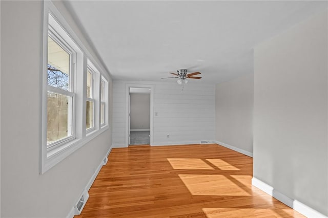 spare room with ceiling fan and light hardwood / wood-style floors