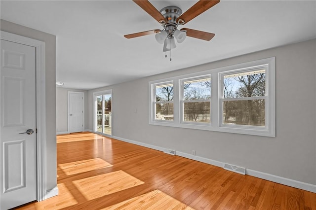 empty room featuring ceiling fan and light wood-type flooring