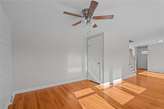 spare room featuring wood-type flooring and ceiling fan