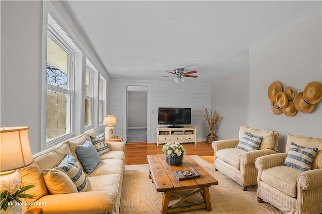 living room featuring ceiling fan and light hardwood / wood-style floors