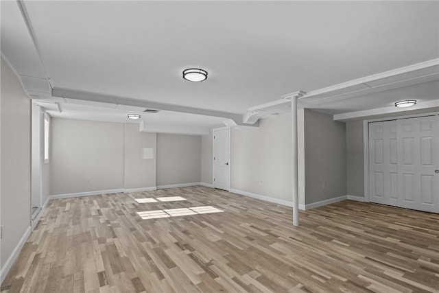 basement with light hardwood / wood-style floors