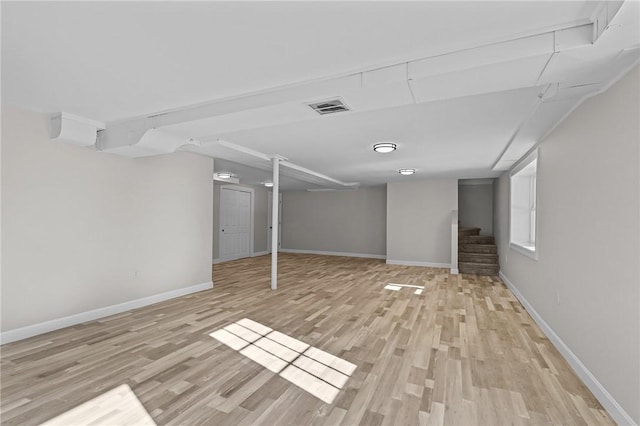 basement with light hardwood / wood-style flooring